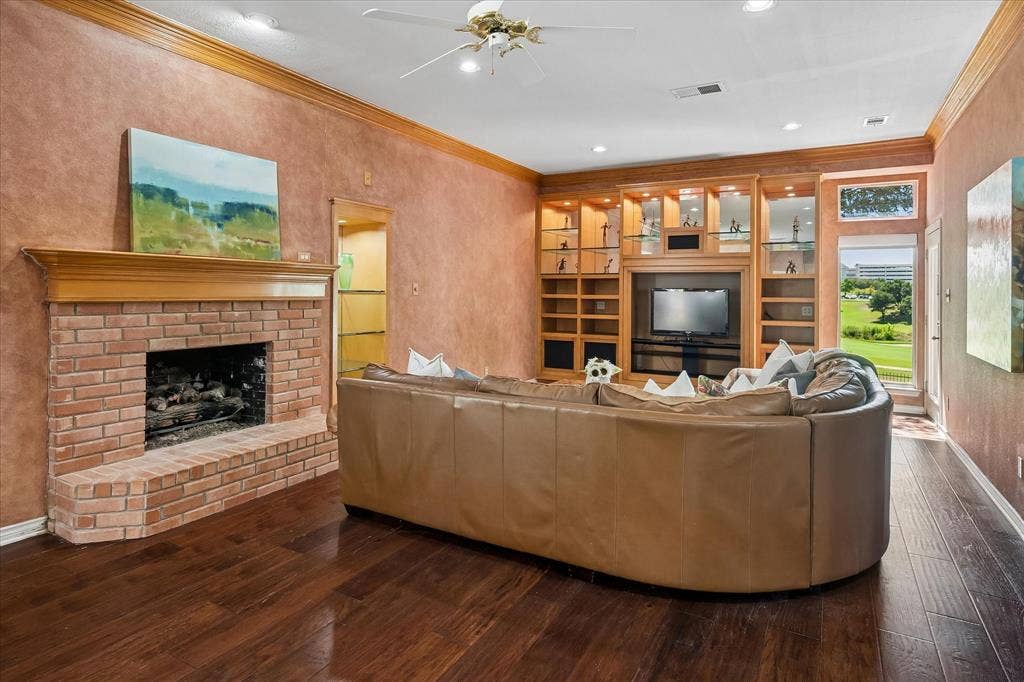 2204 Creekside Circle S, Irving, TX 75063 The room has a cozy feel but is large enough for two seating areas, one by the fireplace and the other for TV or golf viewing