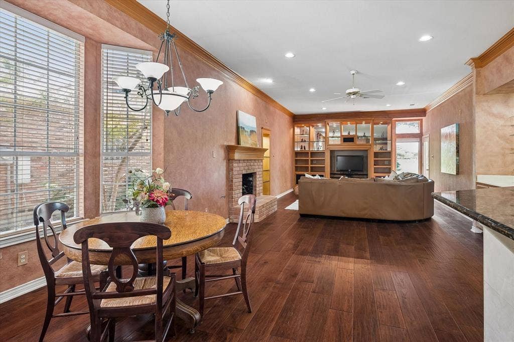 2204 Creekside Circle S, Irving, TX 75063 Beautiful American Hickory hardwood throughout, featuring a brick-surround fireplace, custom built-in entertainment center, and plenty of room for a large breakfast table!