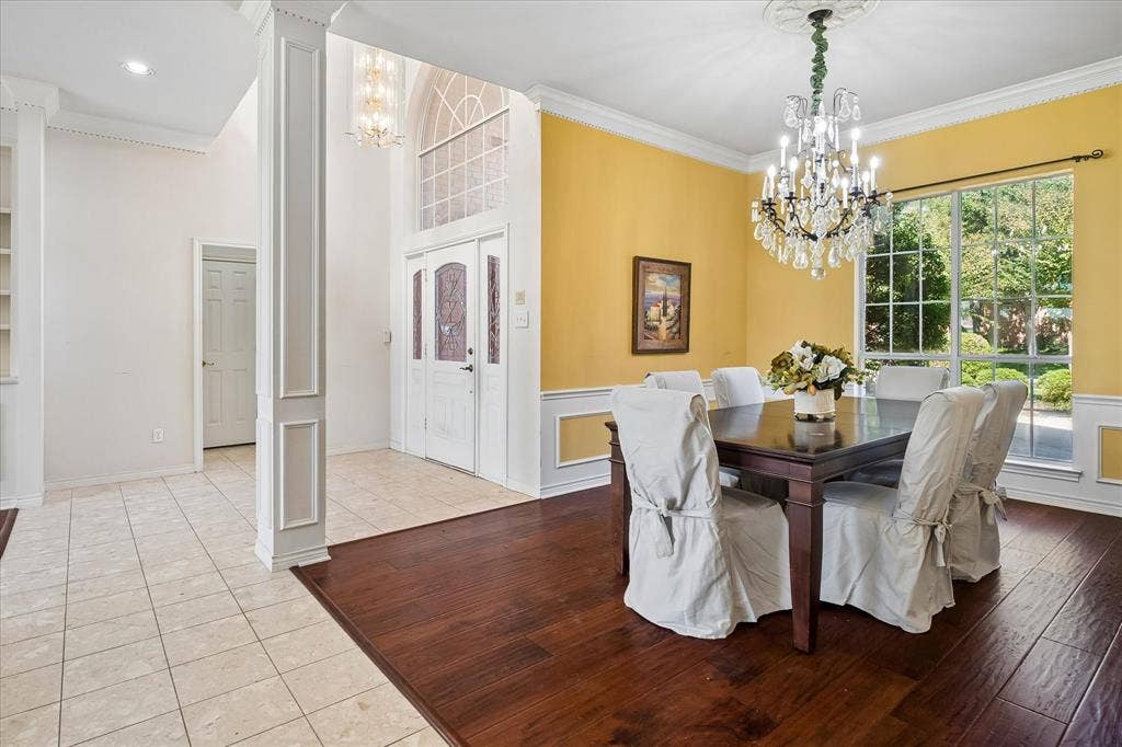 2204 Creekside Circle S, Irving, TX 75063 Formal dining space with American Hickory Hardwood, a crystal chandelier, and large window