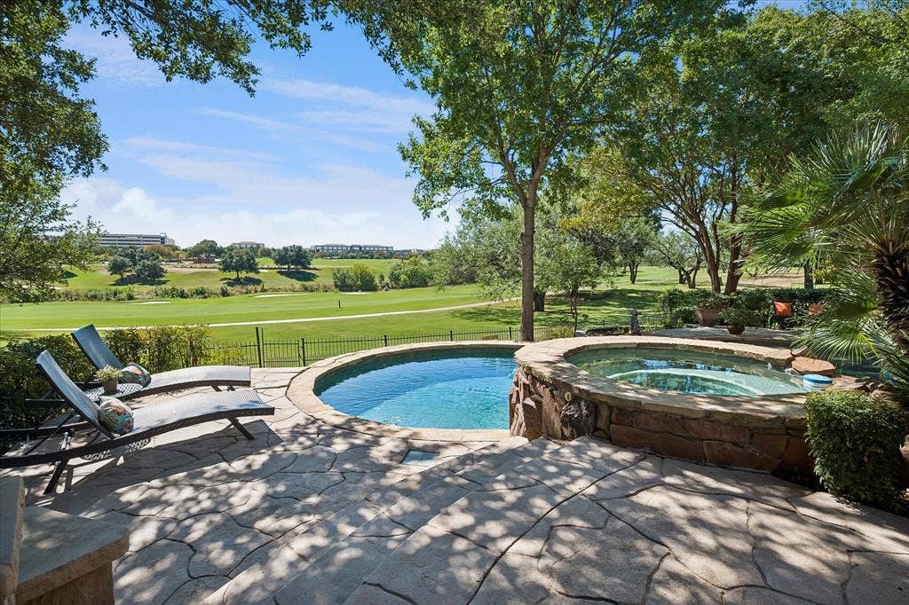 2204 Creekside Circle S, Irving, TX 75063 Additional patio surrounded by mature trees, and a golf course and creek backdrop