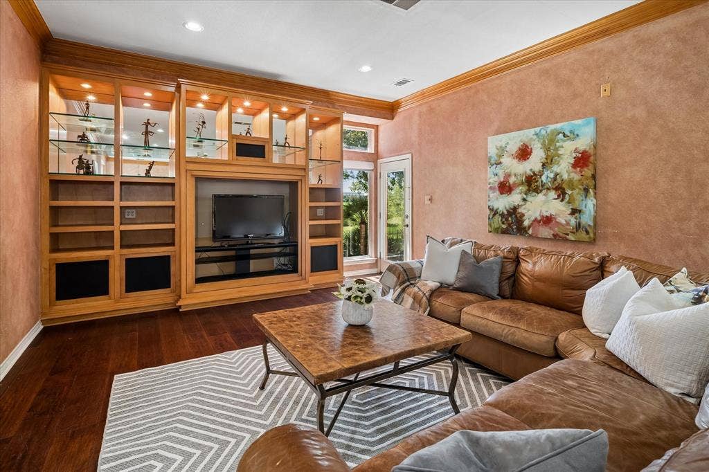 2204 Creekside Circle S, Irving, TX 75063 Built-in entertainment center with display shelving and integrated lighting.