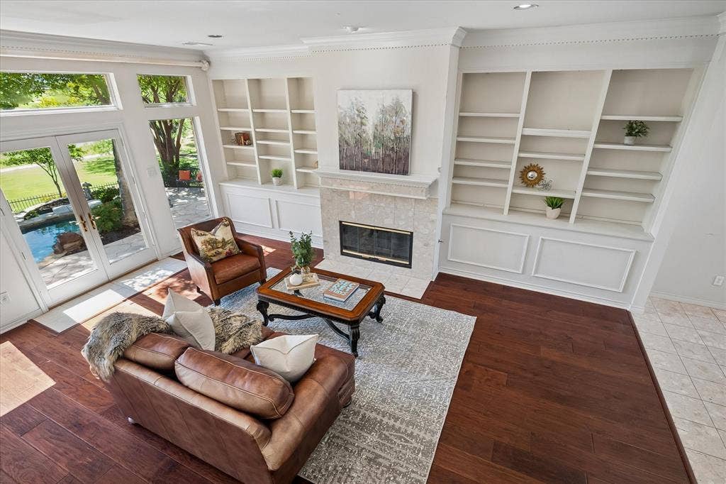 2204 Creekside Circle S, Irving, TX 75063 American Hickory hardwood, built-in shelving, stone-surround fireplace, and French doors leading to the outdoor oasis.