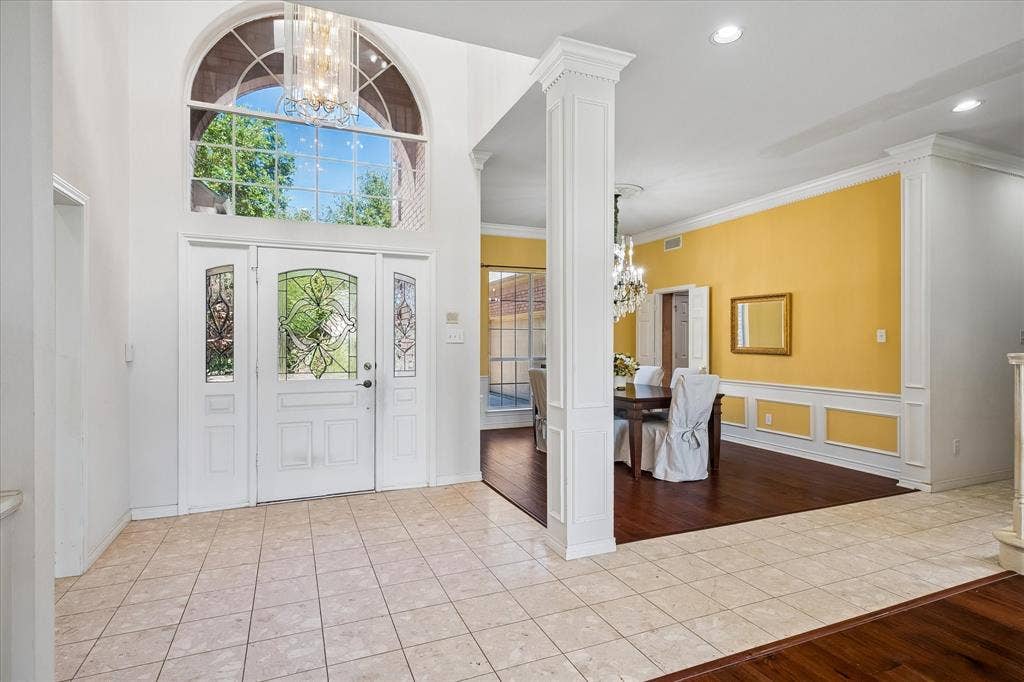 2204 Creekside Circle S, Irving, TX 75063 Grand entryway featuring a white double door with leaded glass panels, an arched transom window, and a decorative chandelier