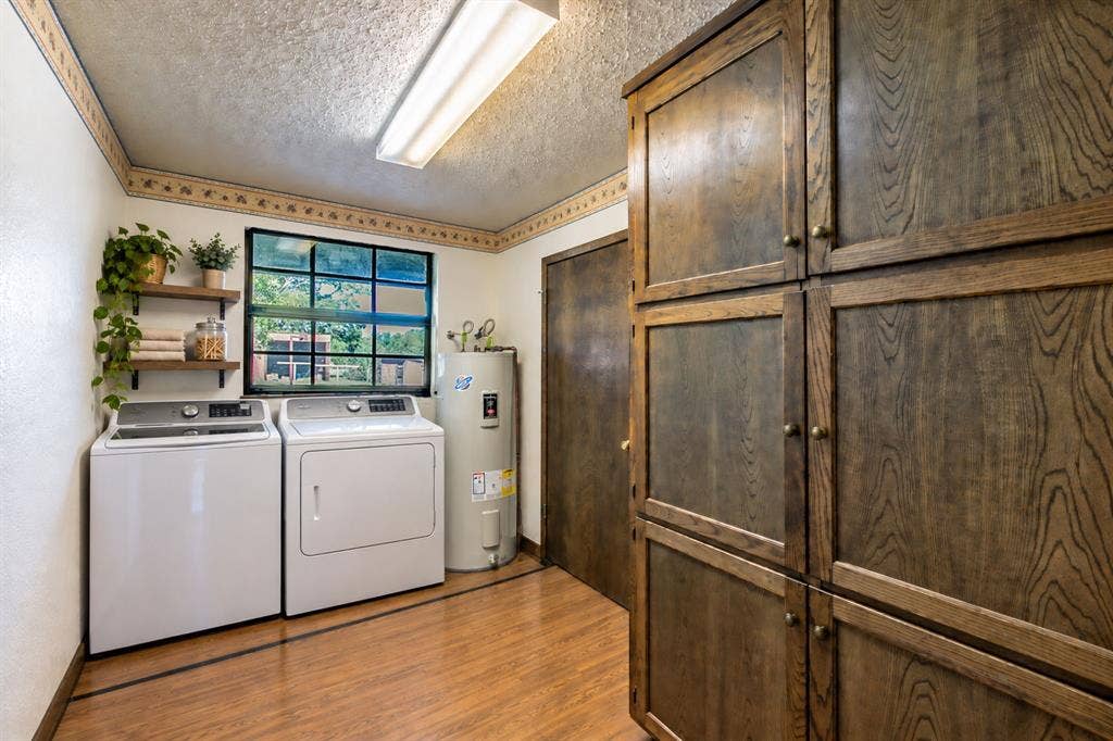 118 Spring Lake Drive, Lacy Lakeview, TX 76705 Wood-finish flooring, built-in storage cabinetry, two floating wood shelves, and a water heater