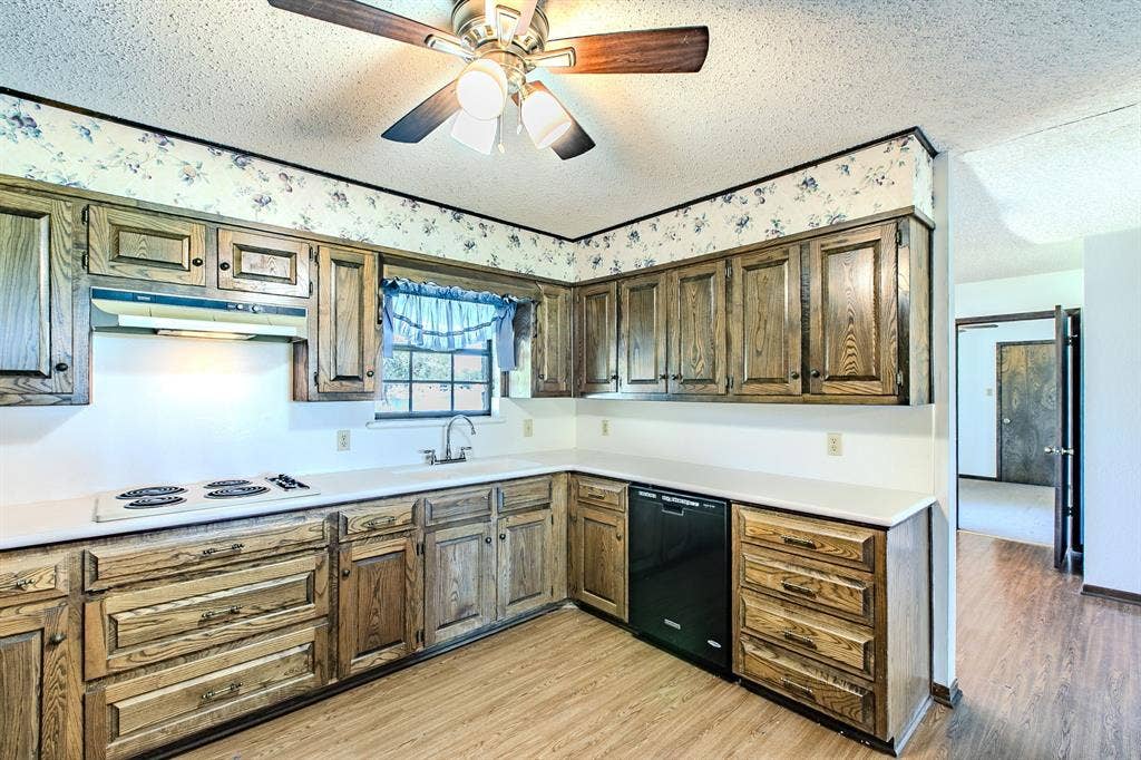 118 Spring Lake Drive, Lacy Lakeview, TX 76705 Kitchen with wood-finish cabinetry, white countertops, built-in stovetop, and overhead ventilation