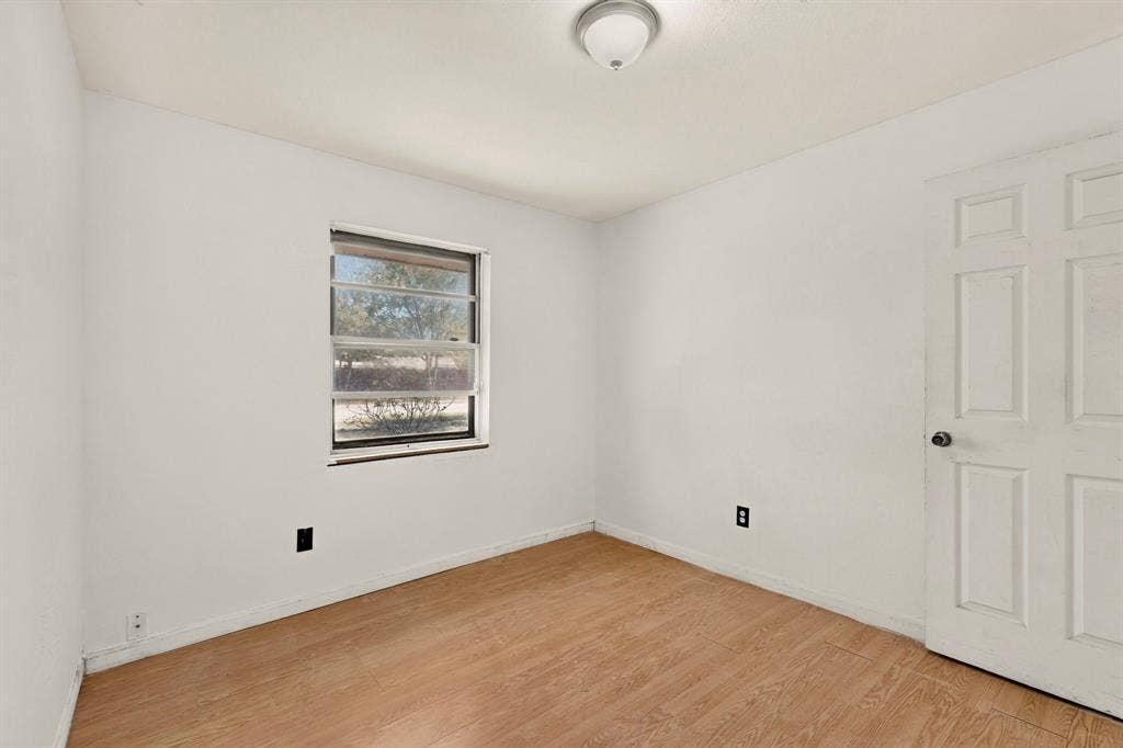 Neutral wall color with wood-finish flooring