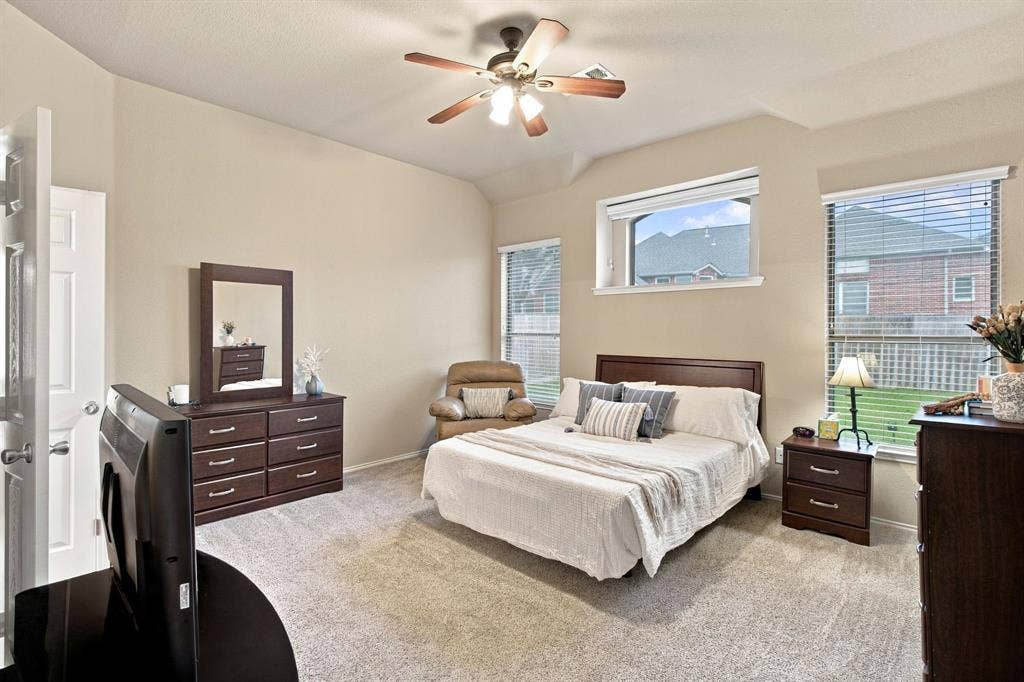 4220 Boxwood Drive, Denton, TX 76208 Lots of windows in this spacious primary bedroom with ensuite bathroom, double vanities, walk in closet.