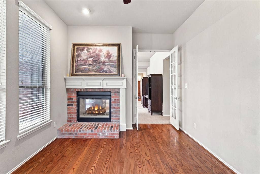 4220 Boxwood Drive, Denton, TX 76208 Very nice study with hardwood flooring and a double sided fireplace to enjoy a cozy work space or reading nook.