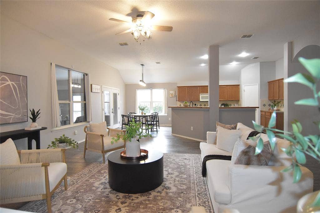 215 Longhorn Trail, Grand Prairie, TX 75052 Vaulted ceiling with a ceiling fan, wood-finish flooring, recessed lighting, double French doors, and an open-concept kitchen with light wood cabinetry