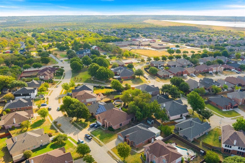 215 Longhorn Trail, Grand Prairie, TX 75052 Aerial perspective of a residential neighborhood featuring detached homes with varied rooflines and a mix of brick and siding exteriors