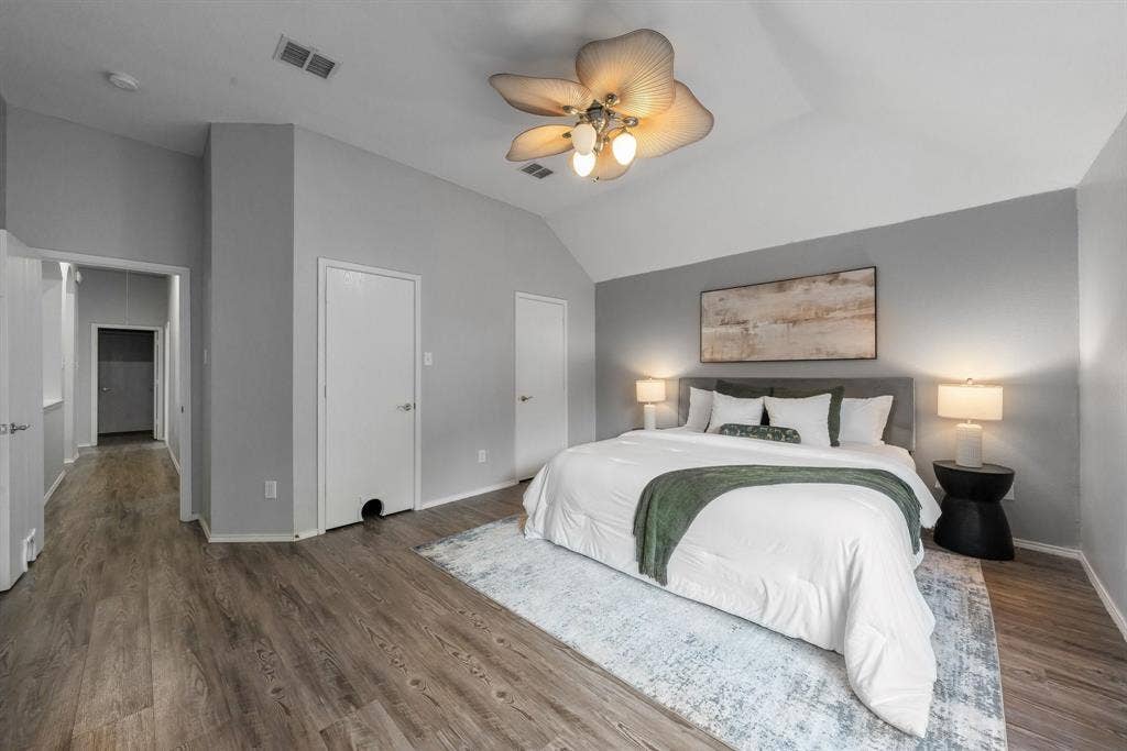 215 Longhorn Trail, Grand Prairie, TX 75052 Vaulted ceiling, ceiling fan with integrated lighting, wood-finish flooring, two panel interior doors, and recessed lighting in the hallway