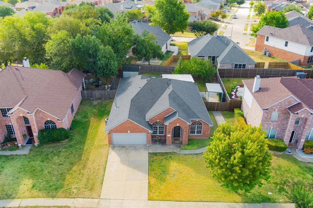 215 Longhorn Trail, Grand Prairie, TX 75052 Brick exterior with a dark-shingle roof