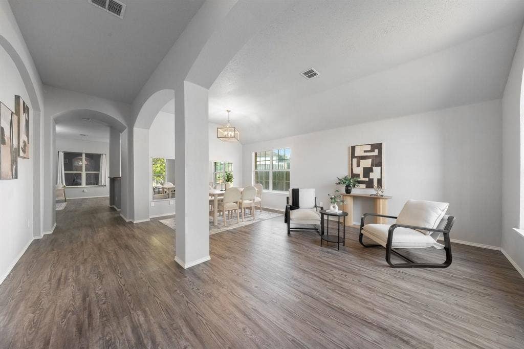 215 Longhorn Trail, Grand Prairie, TX 75052 Wood-finish flooring throughout, multiple arched doorways, vaulted ceiling, and recessed lighting