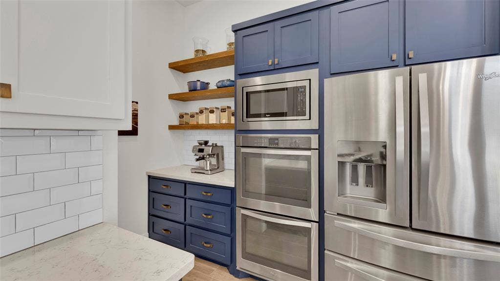 5925 Mayhew Court, McKinney, TX 75070 Stainless-Steel appliances, double-oven, coffee bar with shelving and additional storage.