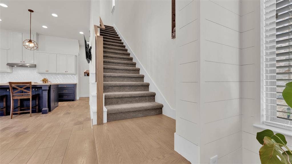 5925 Mayhew Court, McKinney, TX 75070 Stairs leading up to floor 2 from living and kitchen area.