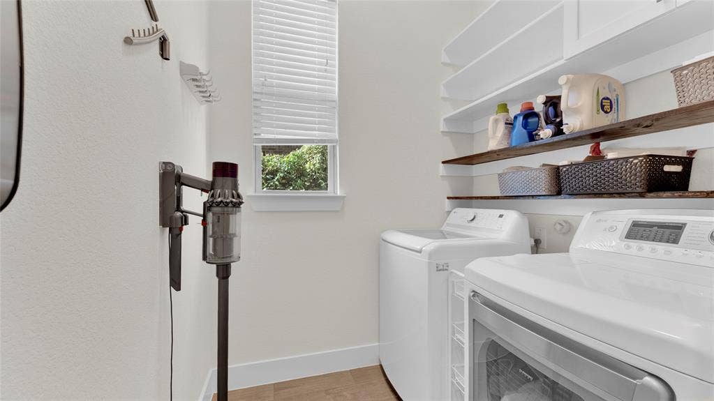 5925 Mayhew Court, McKinney, TX 75070 Floor 1: Laundry. Shelving and cabinet above washer and dryer. Cleaning-tool organizer rack. Two drying racks.