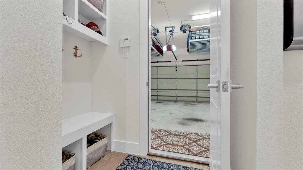 5925 Mayhew Court, McKinney, TX 75070 Floor 1: Mud Room. View of garage two motorized overhead storage lift systems.