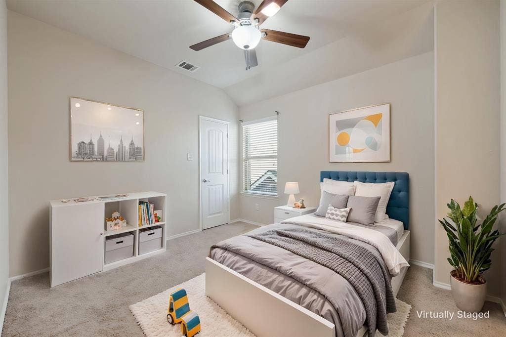 9801 Moccasin Creek Lane, McKinney, TX 75071 Carpeted bedroom featuring a vaulted ceiling with a ceiling fan, a window with blinds, and a white paneled door