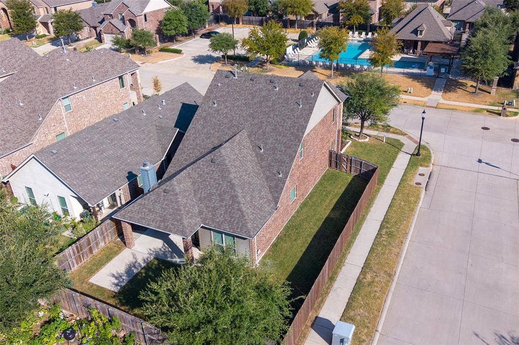 9801 Moccasin Creek Lane, McKinney, TX 75071 Brick exterior, fenced yard, paved driveway, concrete sidewalk, shingle roofing