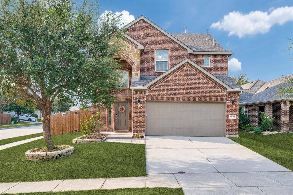 9801 Moccasin Creek Lane, McKinney, TX 75071 Brick facade with stone accents and an arched window