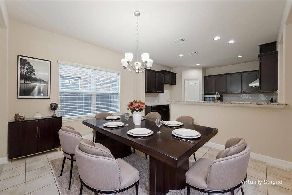 9801 Moccasin Creek Lane, McKinney, TX 75071 Recessed lighting, tiled flooring, built-in cabinetry, and a kitchen pass-through with a stone-finish countertop