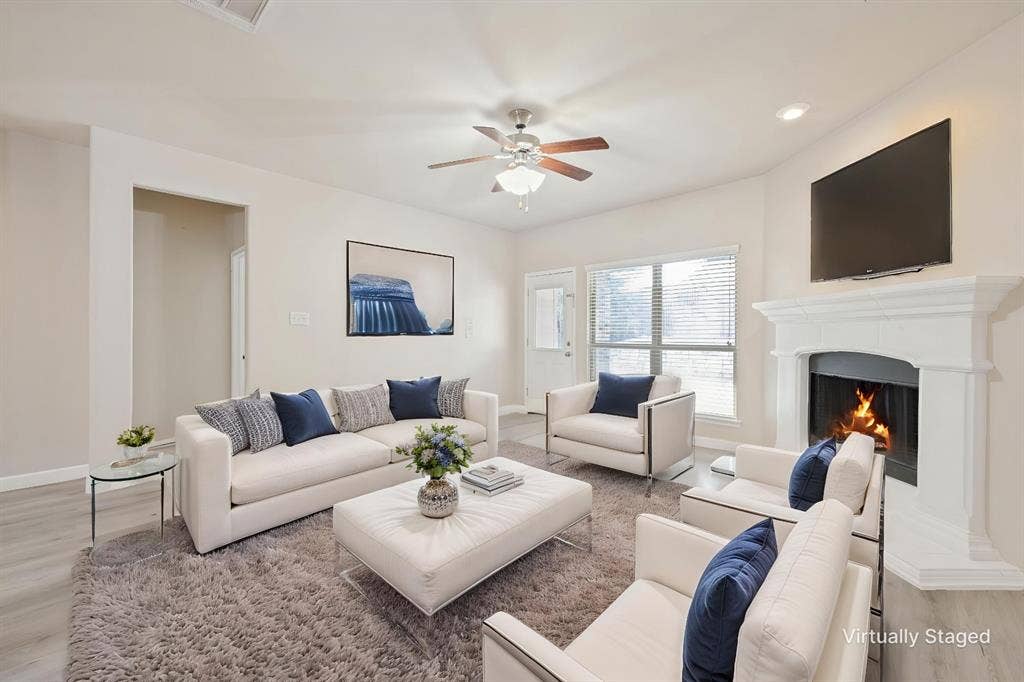 9801 Moccasin Creek Lane, McKinney, TX 75071 Living area featuring a fireplace with a white mantel, ceiling fan, recessed lighting, and wood-finish flooring