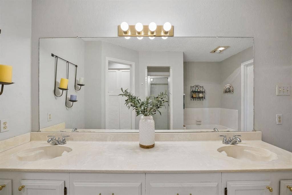 1902 Wyatt Drive, Garland, TX 75040 Dual vanity with integrated sinks and expansive wall-mounted mirror