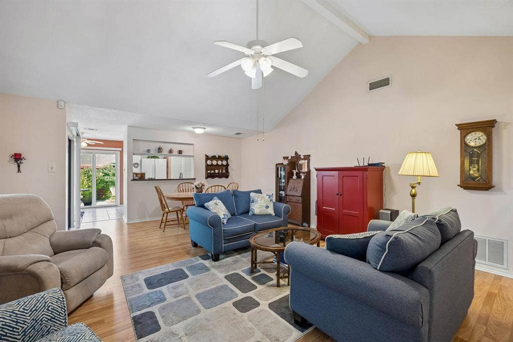 1902 Wyatt Drive, Garland, TX 75040 Vaulted ceiling with exposed beam, wood-finish flooring, ceiling fan, and built-in shelving in dining area