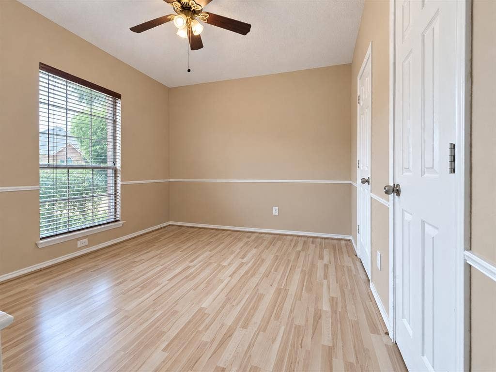 2504 Indian Paint Drive, Plano, TX 75025 Wood-finish flooring, ceiling fan with integrated lighting, window with blinds, and paneled doors
