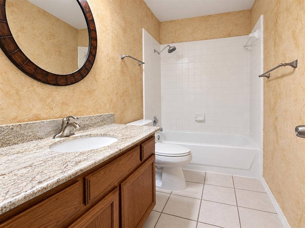 2504 Indian Paint Drive, Plano, TX 75025 Vanity with a granite-style countertop, a built-in sink, and a brushed nickel faucet