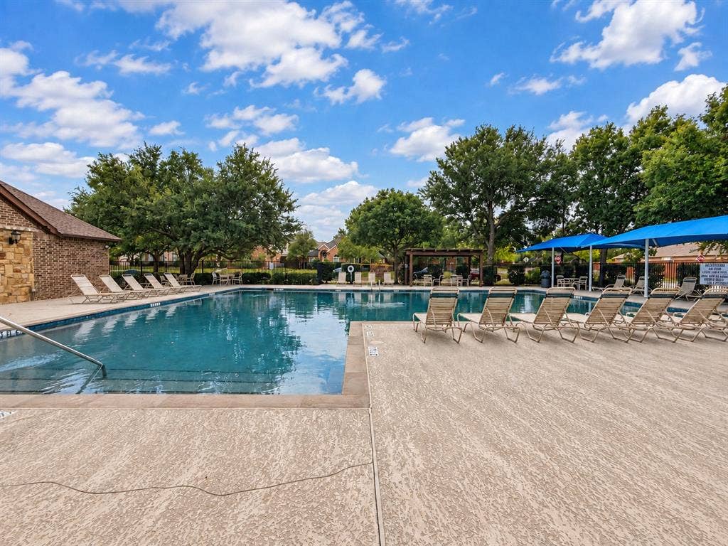 2504 Indian Paint Drive, Plano, TX 75025 Swimming pool with integrated steps and a wide surrounding deck