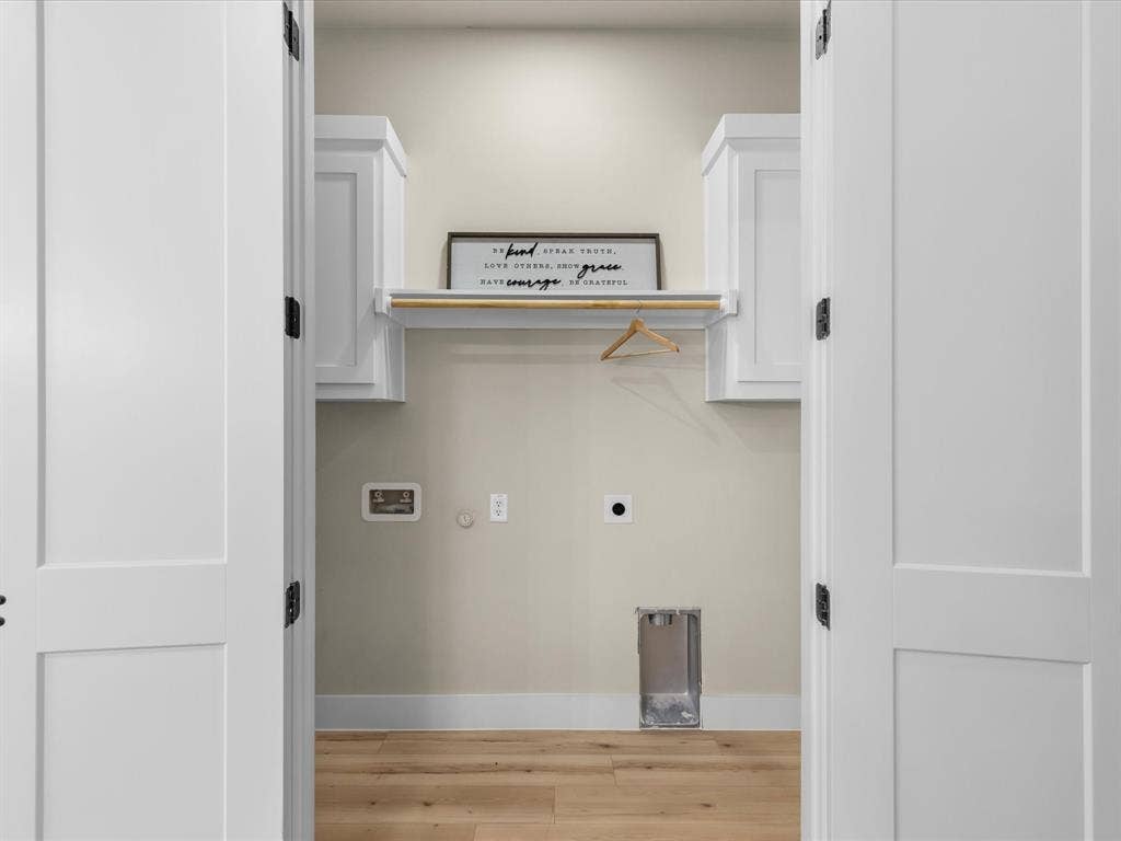 2127 Amanda Avenue, Fort Worth, TX 76105 White panel doors, wood-finish flooring, light-toned walls, and white cabinetry with a built-in hanging rod