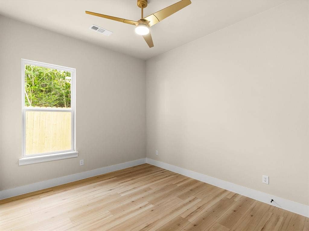 2127 Amanda Avenue, Fort Worth, TX 76105 Neutral wall paint, wood-finish flooring, and a modern ceiling fan with integrated lighting