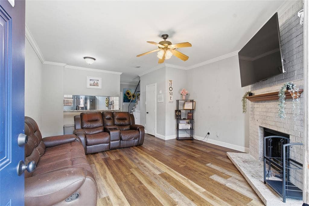212 Samuel Boulevard, #3, Coppell, TX 75019 Wood-finish flooring, brick-surround fireplace with hearth, ceiling fan, crown molding, and recessed lighting