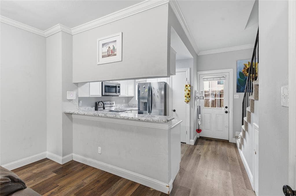 212 Samuel Boulevard, #3, Coppell, TX 75019 Wood-finish flooring throughout, with a kitchen pass-through featuring a granite-style countertop