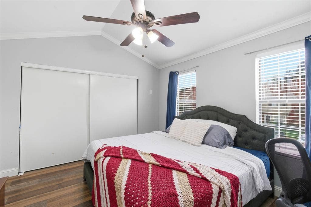 212 Samuel Boulevard, #3, Coppell, TX 75019 Vaulted ceiling with a ceiling fan, dual windows with blinds, sliding closet doors, and wood-finish flooring