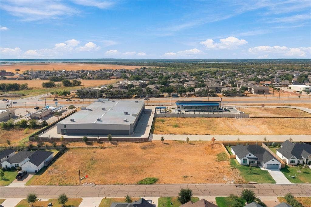 9932 Bridlewood Lane, Waco, TX 76708 Expansive undeveloped lot with surrounding residential and commercial properties