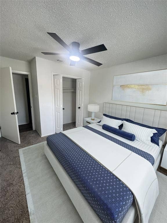 4639 Williams Road, #219, Benbrook, TX 76116 Carpeted bedroom featuring a textured ceiling, a closet, and ceiling fan