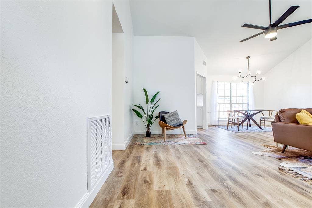 8341 Edgewater Drive, Frisco, TX 75034 Vaulted ceiling with a black ceiling fan and a modern chandelier
