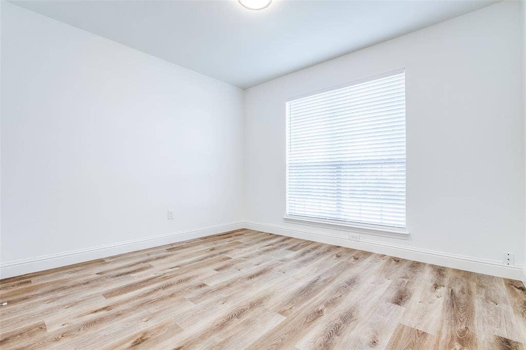 8341 Edgewater Drive, Frisco, TX 75034 Wood-finish flooring, white walls, window with blinds, and recessed lighting