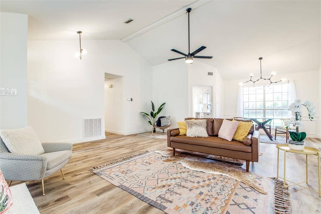 8341 Edgewater Drive, Frisco, TX 75034 Vaulted ceiling with an installed ceiling fan, wood-finish flooring, and a modern chandelier