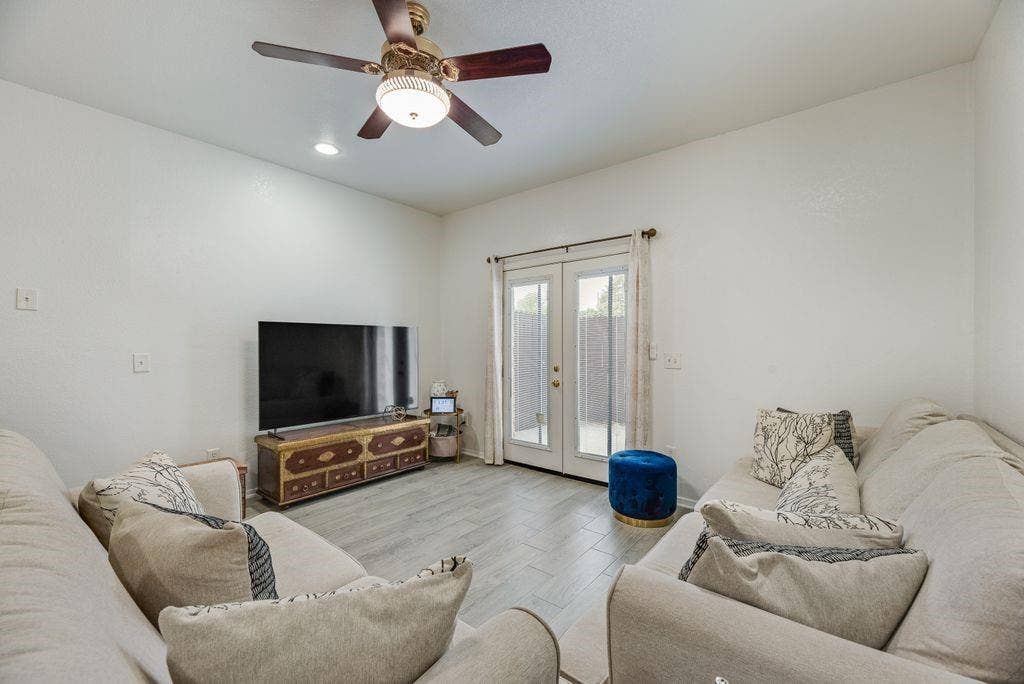 3801 14th Street, #1905, Plano, TX 75074 Recessed lighting, ceiling fan with integrated light fixture, wood-finish flooring, and double French doors with transom windows