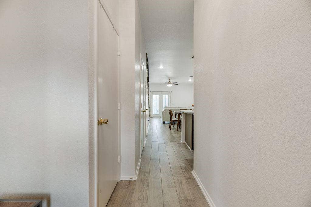 3801 14th Street, #1905, Plano, TX 75074 Hallway featuring wood-finish flooring, white doors with brass hardware, and recessed lighting