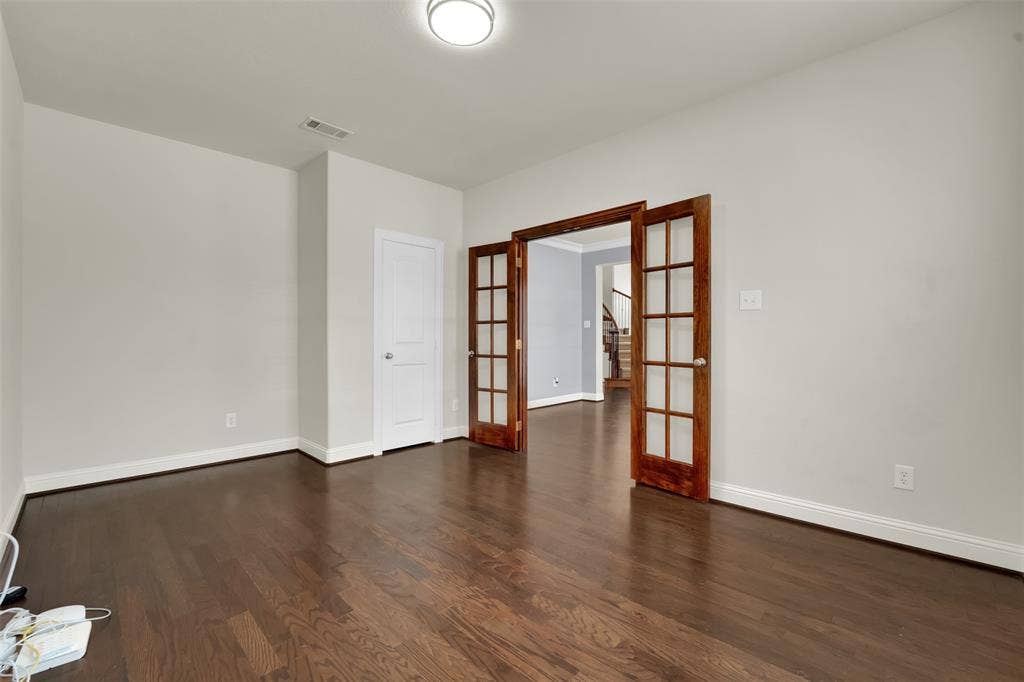 6811 Shady View Court, Sachse, TX 75048 Hardwood flooring, white baseboards, and neutral wall paint