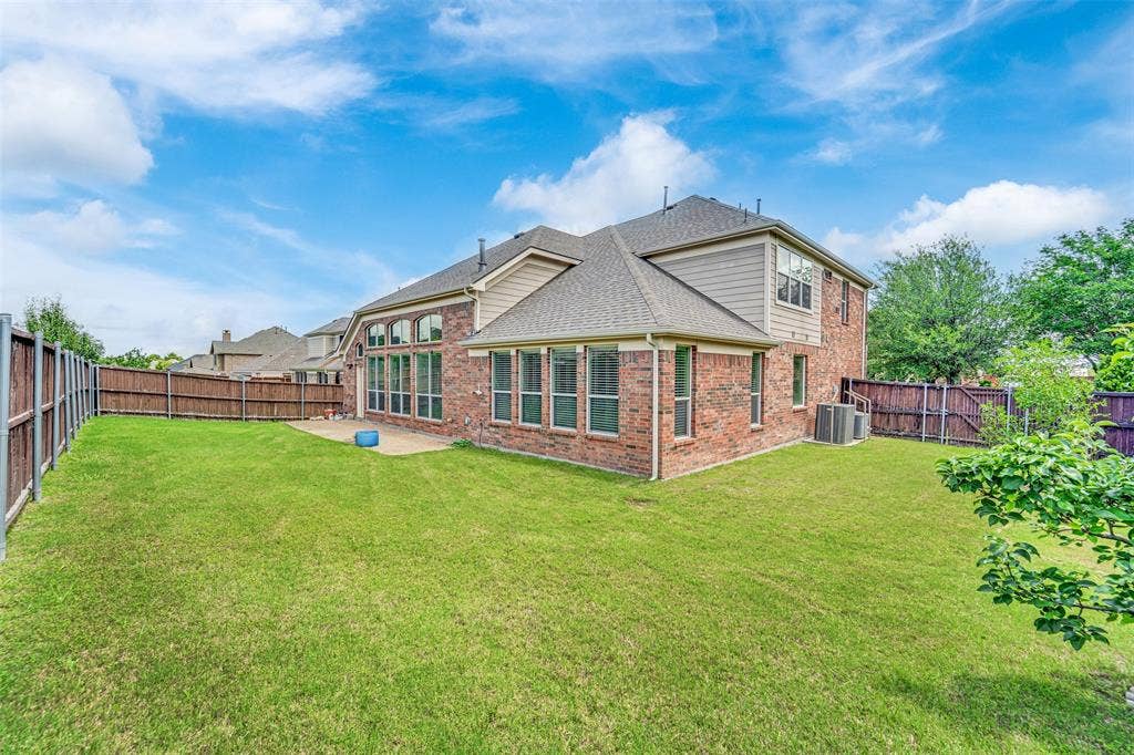 6811 Shady View Court, Sachse, TX 75048 Expansive green lawn with a patio area