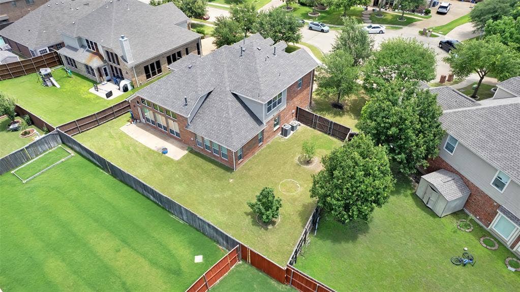 6811 Shady View Court, Sachse, TX 75048 Brick exterior with a gray shingle roof and multiple windows
