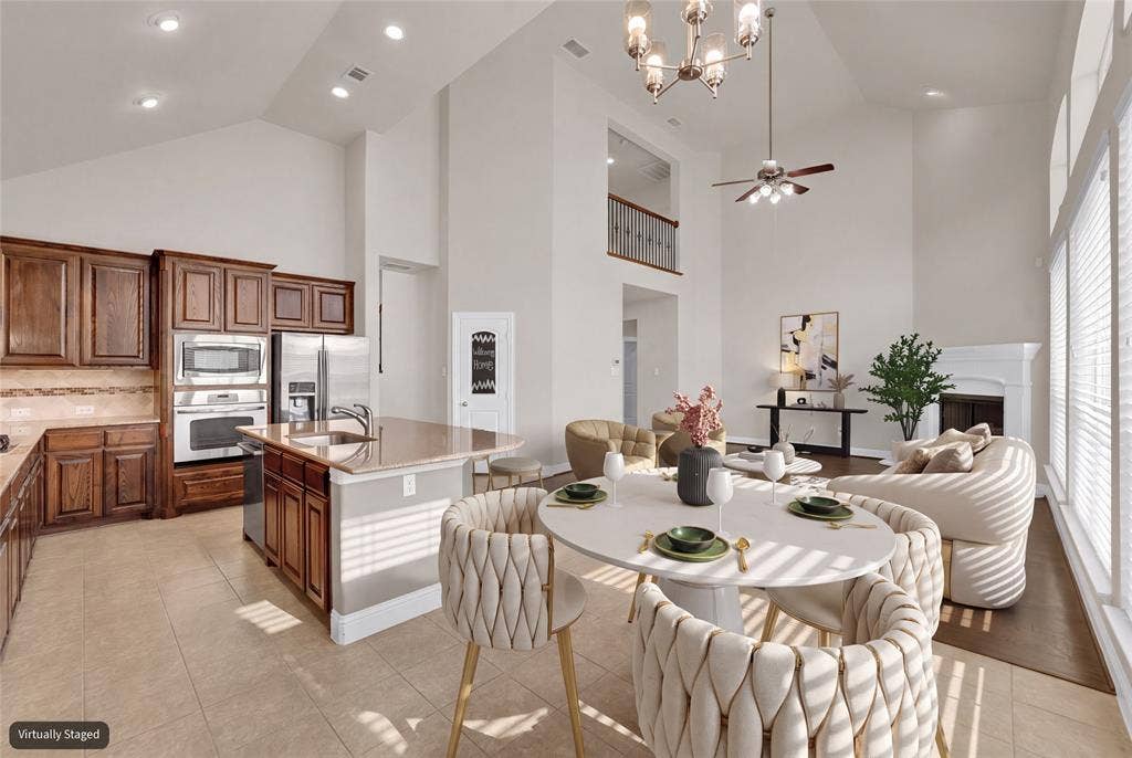 6811 Shady View Court, Sachse, TX 75048 Spacious open-concept interior featuring a kitchen island with a built-in sink, stainless steel appliances, and wood cabinetry