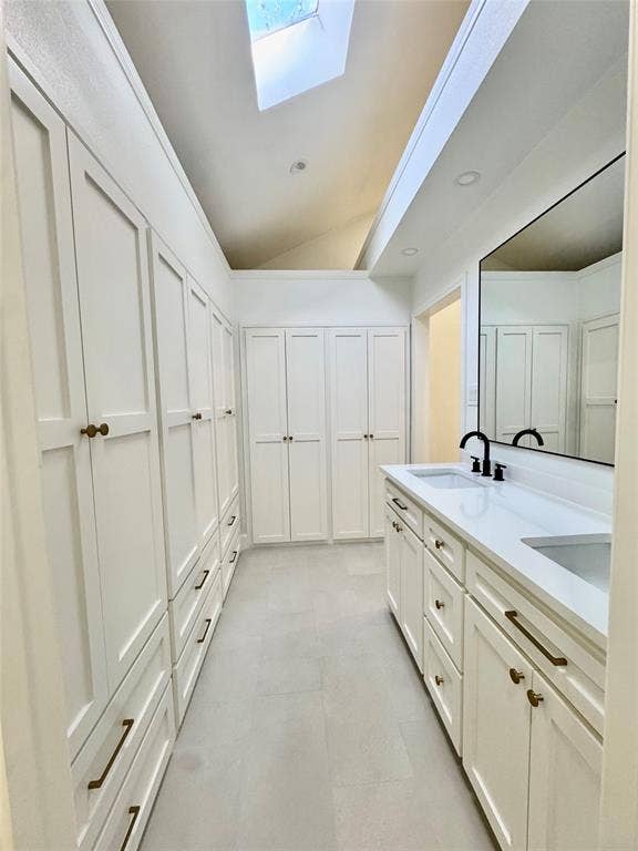3706 Aries Drive, Garland, TX 75044 Dual skylights, extensive built-in cabinetry, dual vanity with undermount sinks, and matte black plumbing fixtures