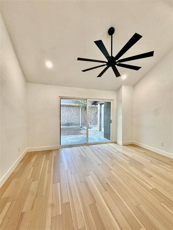 3706 Aries Drive, Garland, TX 75044 Vaulted ceiling with recessed lighting, wood-finish flooring, modern black ceiling fan, and sliding glass door