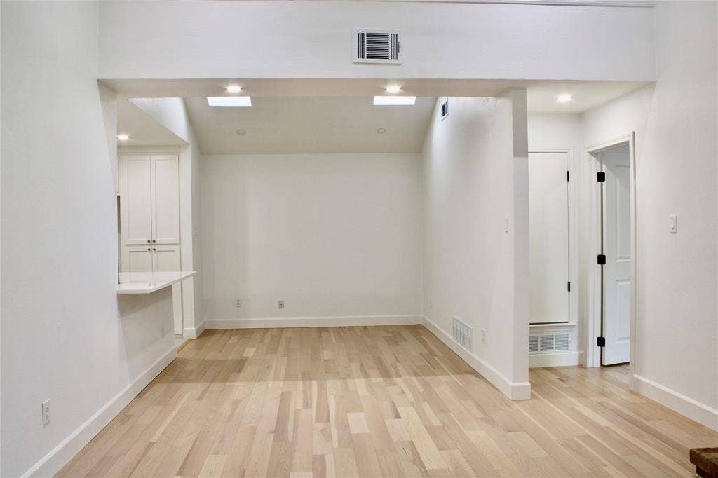 3706 Aries Drive, Garland, TX 75044 Wood-finish flooring, recessed lighting, and skylights enhance the space